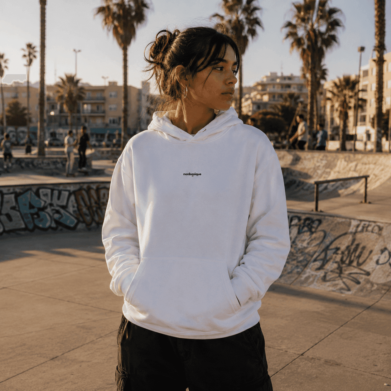 L'Éco Urbain Femme Hoodie in white, worn at a skatepark